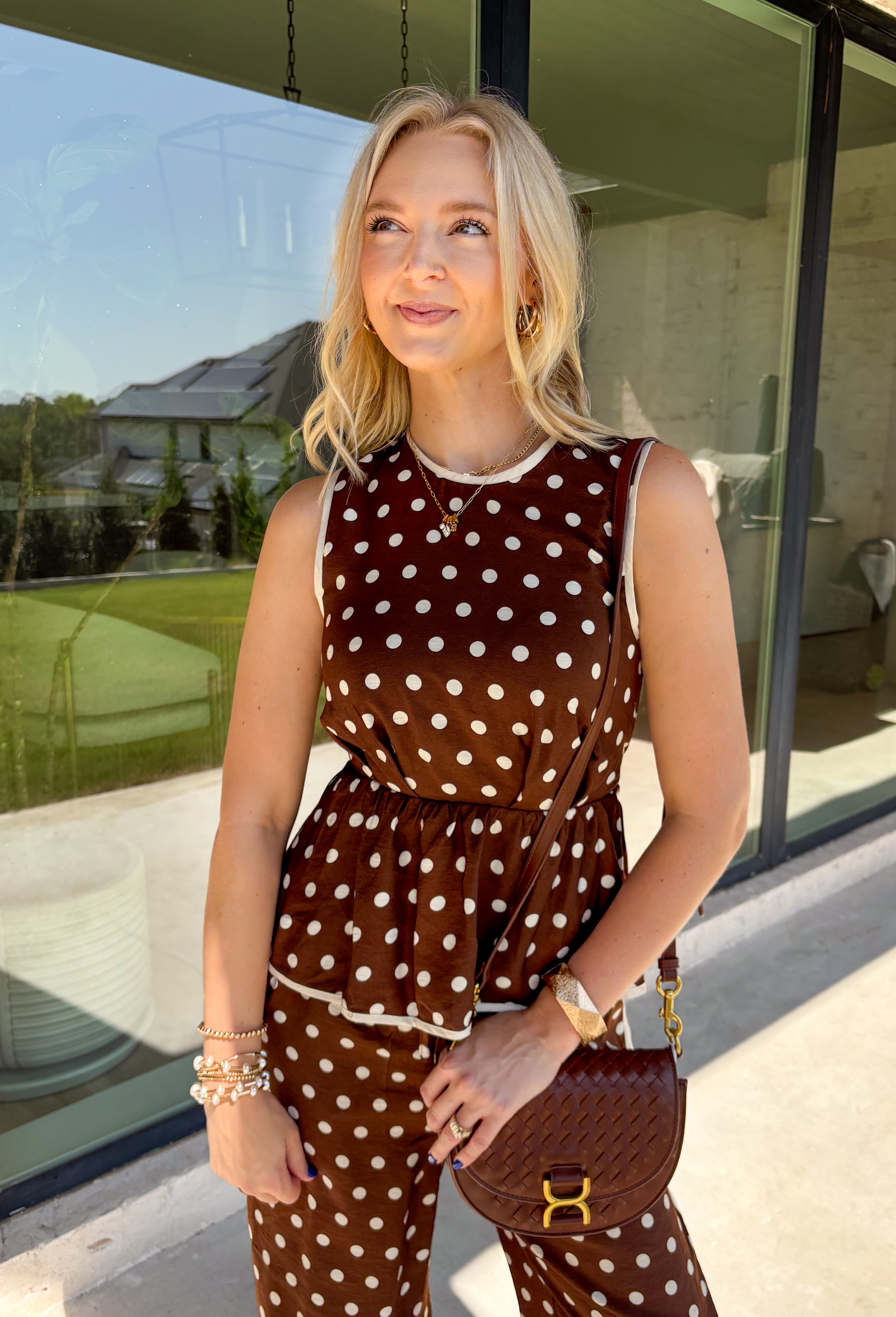 Bring a playful print into your fall wardrobe with this brown and cream polka dot top from Entro. The warm brown background and classic cream dots make it easy to pair with all the rich neutrals of the season, while the contrast trim adds an extra touch of detail. A self-tie at the waist lets you adjust the shape, and the elasticated back waist keeps the fit comfortable throughout the day. 
