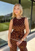 Bring a playful print into your fall wardrobe with this brown and cream polka dot top from Entro. The warm brown background and classic cream dots make it easy to pair with all the rich neutrals of the season, while the contrast trim adds an extra touch of detail. A self-tie at the waist lets you adjust the shape, and the elasticated back waist keeps the fit comfortable throughout the day. 