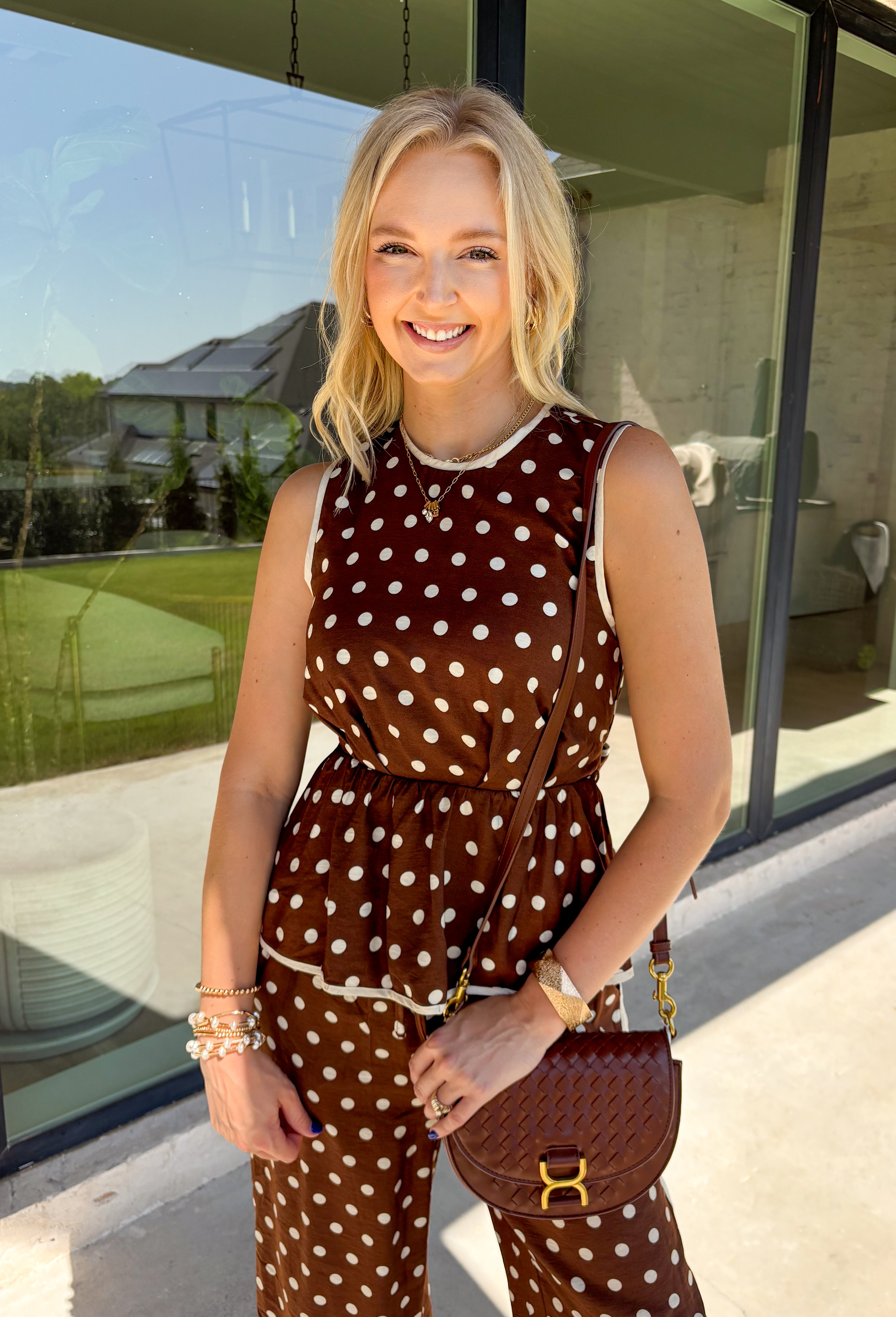 Bring a playful print into your fall wardrobe with this brown and cream polka dot top from Entro. The warm brown background and classic cream dots make it easy to pair with all the rich neutrals of the season, while the contrast trim adds an extra touch of detail. A self-tie at the waist lets you adjust the shape, and the elasticated back waist keeps the fit comfortable throughout the day. 