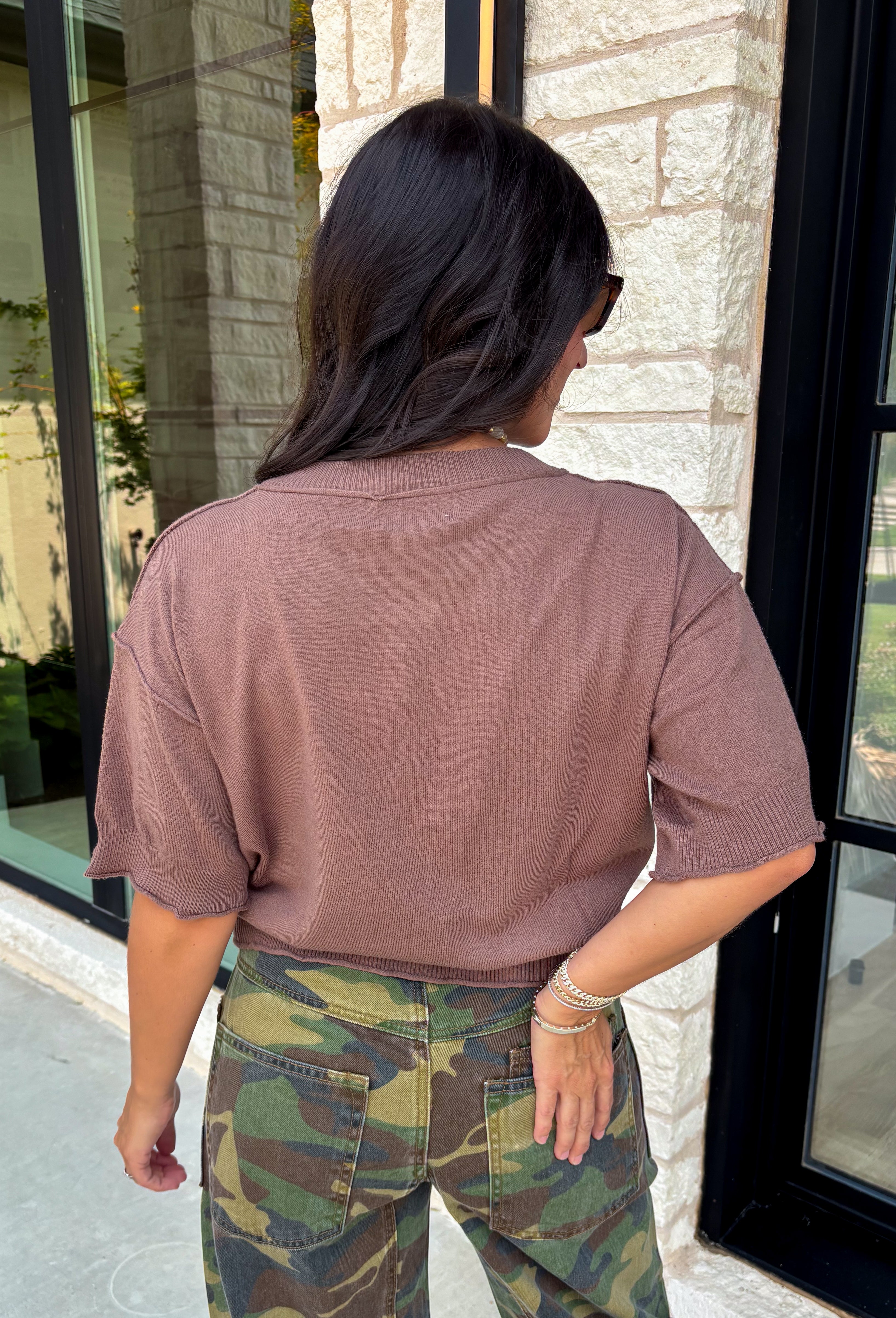 The perfect layering piece has arrived just in time for sweater weather. This chocolate brown cardigan is crafted from a soft sweater knit that makes every outfit feel a little cozier while still looking effortlessly polished. The button-front design gives you endless styling options—wear it buttoned as a top or layered over your favorite tanks and dresses. Finished with exposed hems and classic ribbed trim, this versatile cardigan is one you'll reach for from crisp fall mornings through the holiday season.