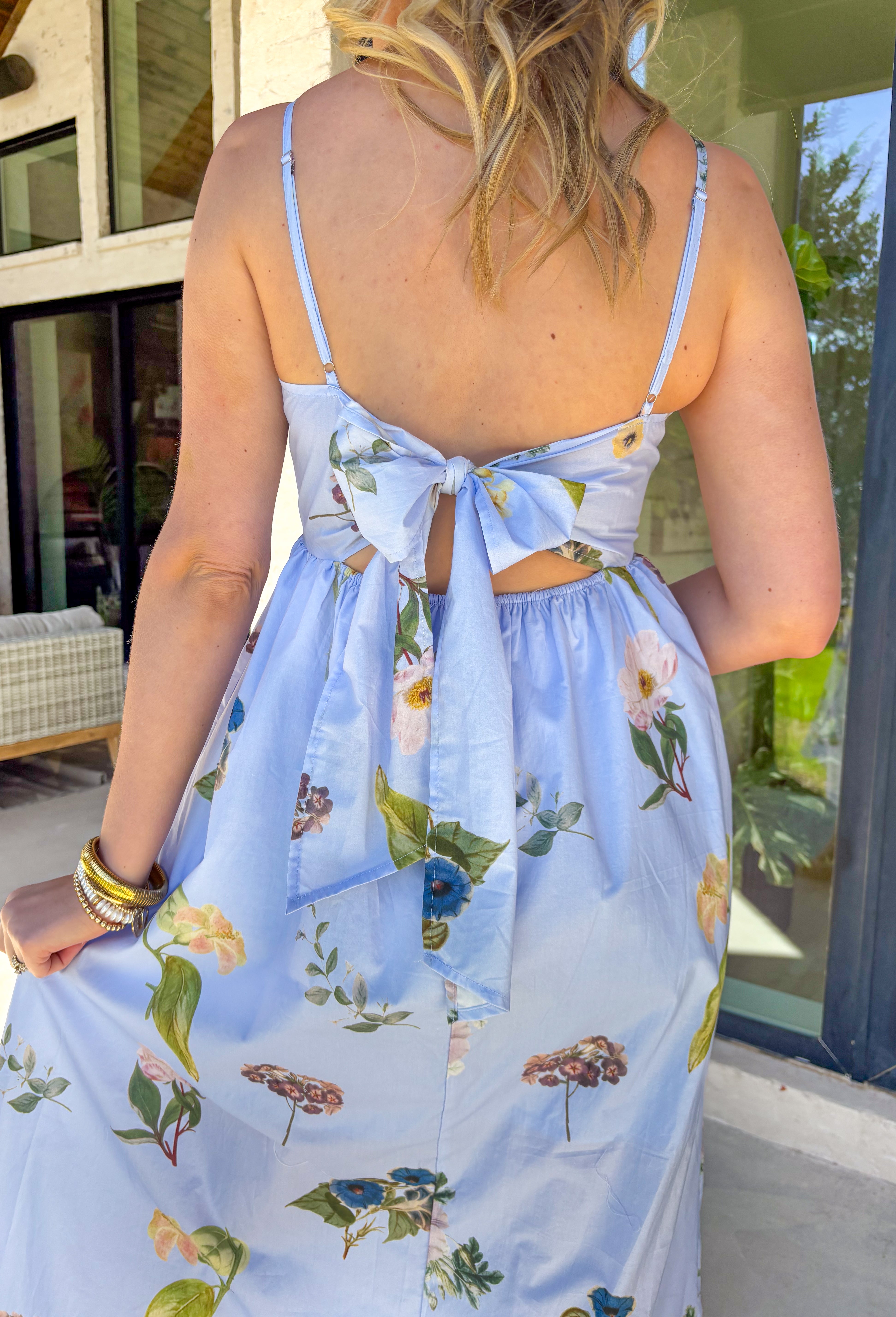 This light blue sleeveless dress is pure springtime sweetness! With a floral print sprinkled throughout, it feels fresh, feminine, and perfect for sunny days ahead. The scalloped neckline and matching scalloped hem add the prettiest little detail that makes this dress feel extra special. The adjustable straps let you customize the fit, and the elastic back with a self-tie detail keeps it comfy while giving you a flattering shape. Fully lined for coverage and finished with side pockets.