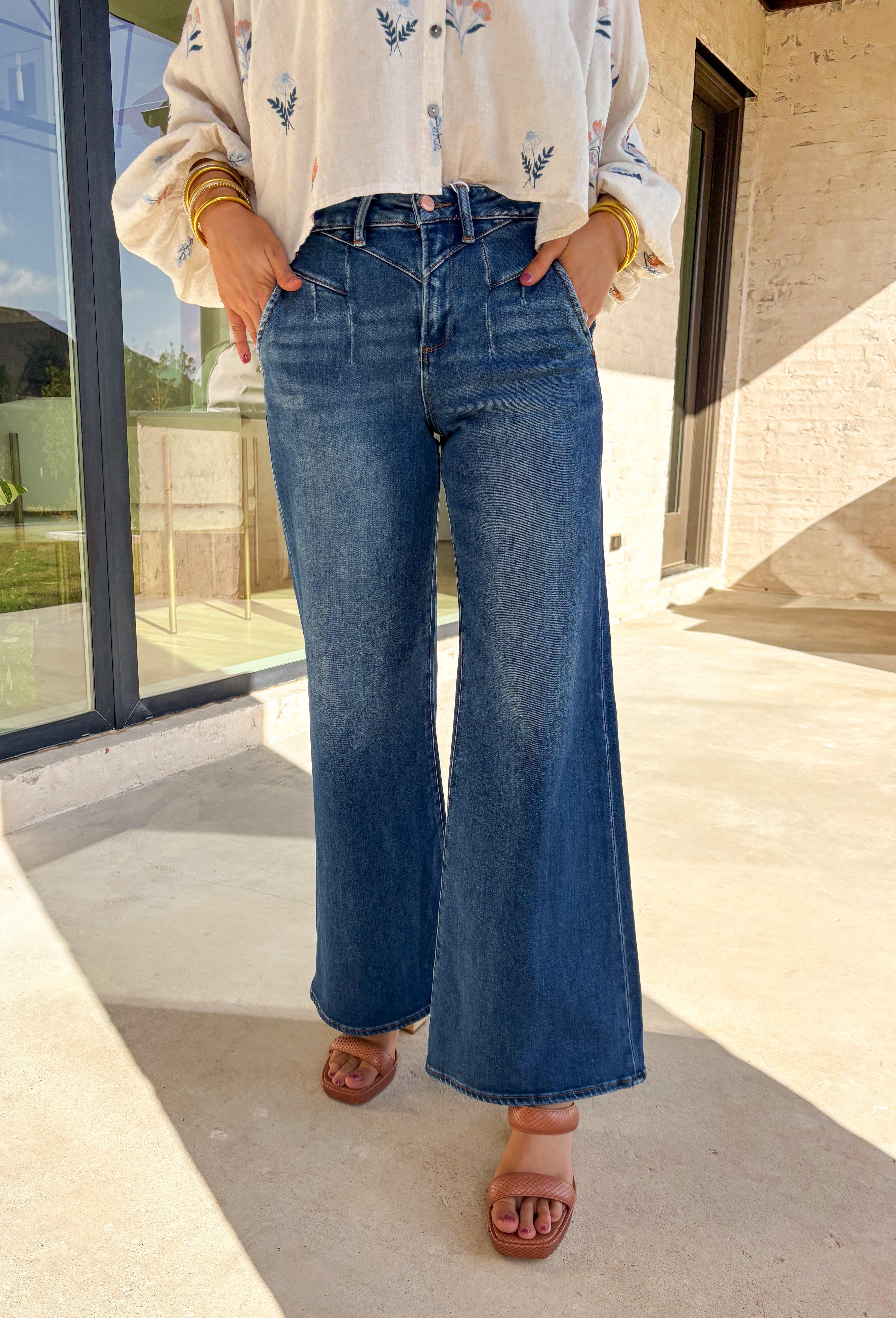 Refresh your denim collection for spring with these dark wash wide leg jeans by Risen. Designed with a flattering high-rise fit and front yoke seam detail, these jeans bring a modern edge to a timeless silhouette. The soft stretch denim and 31" inseam make them perfect for pairing with lightweight blouses, floral tops, or easy tees as the weather warms up.