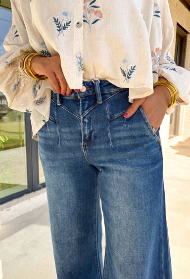 Refresh your denim collection for spring with these dark wash wide leg jeans by Risen. Designed with a flattering high-rise fit and front yoke seam detail, these jeans bring a modern edge to a timeless silhouette. The soft stretch denim and 31" inseam make them perfect for pairing with lightweight blouses, floral tops, or easy tees as the weather warms up.