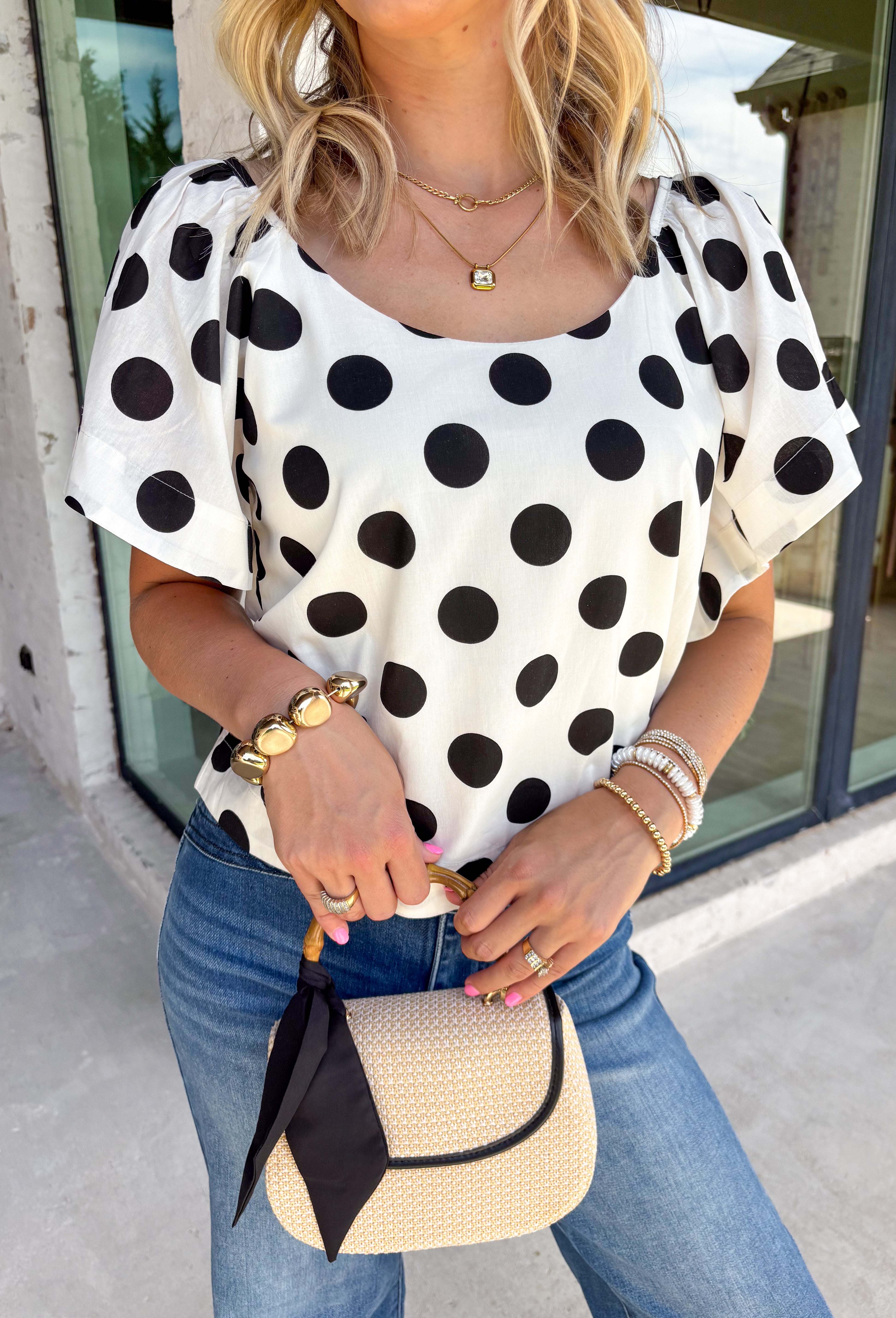 This off white polka dot top is the perfect blend of timeless and on-trend! The classic black polka dot print never goes out of style, while the statement sleeves add a fashion-forward touch that instantly elevates your look. Crafted from breathable cotton, it's lightweight enough to wear now and easy to layer under jackets and cardigans as the seasons change. Whether you're heading to the office, meeting friends for lunch, or dressing up your favorite denim, this top makes looking polished feel effortless.