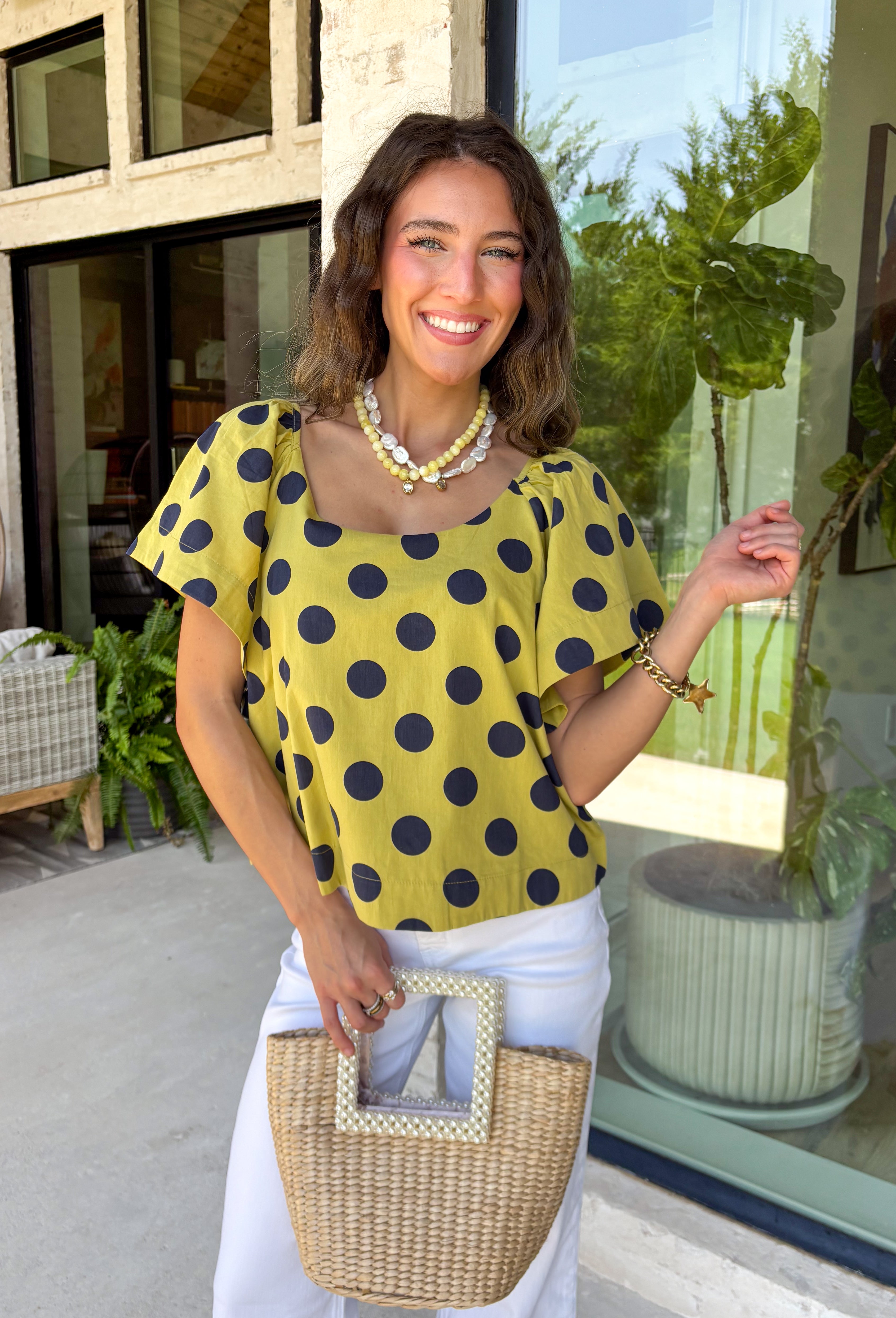 This lime polka dot top is the perfect blend of timeless and on-trend! The classic navy polka dot print never goes out of style, while the statement sleeves add a fashion-forward touch that instantly elevates your look. Crafted from breathable cotton, it's lightweight enough to wear now and easy to layer under jackets and cardigans as the seasons change. Whether you're heading to the office, meeting friends for lunch, or dressing up your favorite denim, this top makes looking polished feel effortless.
