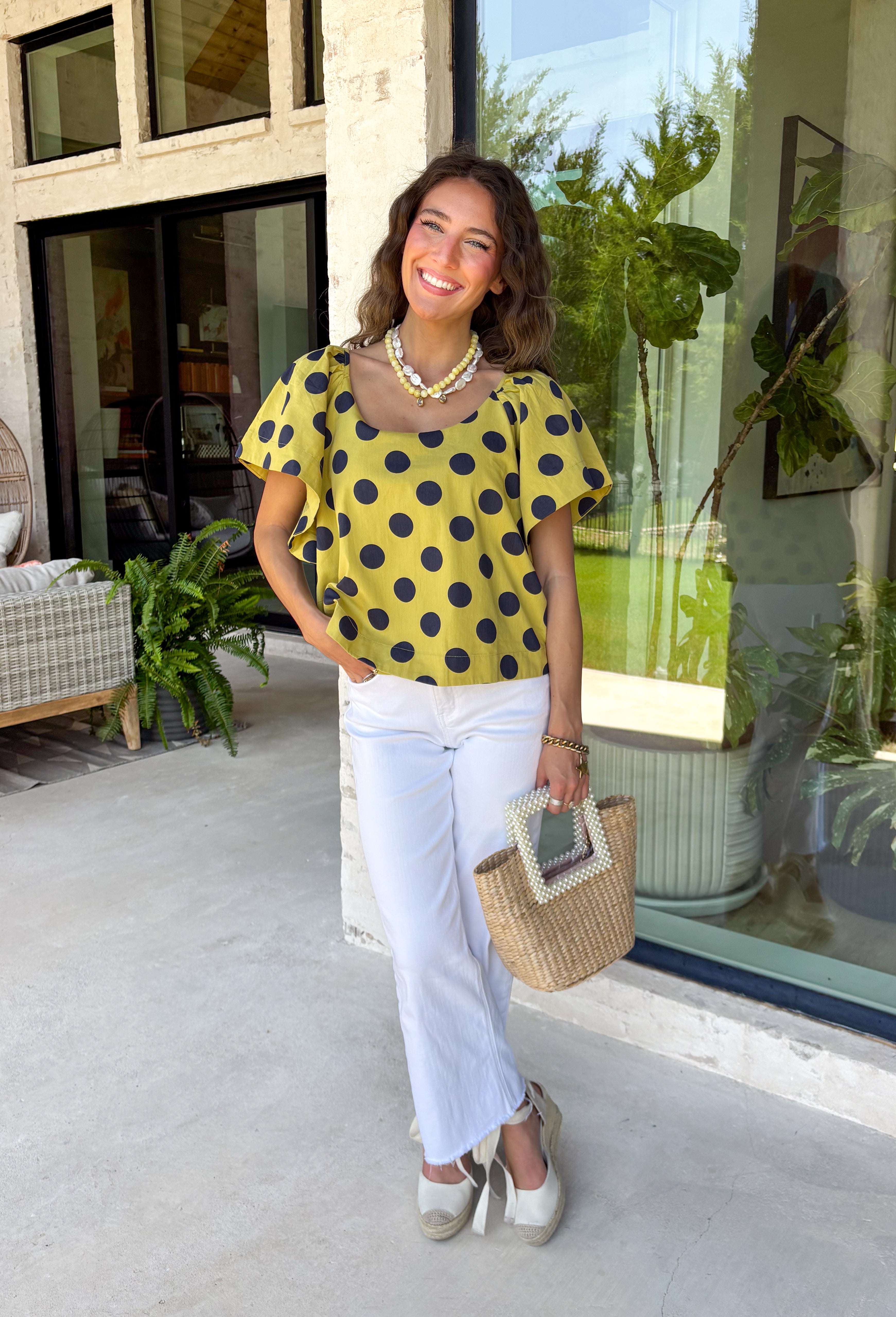 This lime polka dot top is the perfect blend of timeless and on-trend! The classic navy polka dot print never goes out of style, while the statement sleeves add a fashion-forward touch that instantly elevates your look. Crafted from breathable cotton, it's lightweight enough to wear now and easy to layer under jackets and cardigans as the seasons change. Whether you're heading to the office, meeting friends for lunch, or dressing up your favorite denim, this top makes looking polished feel effortless.