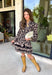 Chic, timeless, and effortlessly feminine, this floral dress is made for every special moment on your fall calendar. Featuring a classic black backdrop with a beautiful tan and off-white floral print, this dress offers a sophisticated look that's easy to wear from day to night. The button-front bodice, long sleeves, and tiered skirt create a flattering silhouette with graceful movement, while the elastic cuffs add a comfortable finishing touch. 