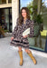Chic, timeless, and effortlessly feminine, this floral dress is made for every special moment on your fall calendar. Featuring a classic black backdrop with a beautiful tan and off-white floral print, this dress offers a sophisticated look that's easy to wear from day to night. The button-front bodice, long sleeves, and tiered skirt create a flattering silhouette with graceful movement, while the elastic cuffs add a comfortable finishing touch. 