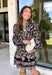Chic, timeless, and effortlessly feminine, this floral dress is made for every special moment on your fall calendar. Featuring a classic black backdrop with a beautiful tan and off-white floral print, this dress offers a sophisticated look that's easy to wear from day to night. The button-front bodice, long sleeves, and tiered skirt create a flattering silhouette with graceful movement, while the elastic cuffs add a comfortable finishing touch. 