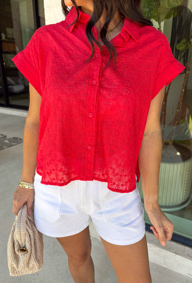 Bold, feminine, and perfect for sunny days! This red short sleeve button down top features beautiful eyelet lace throughout, adding texture and charm to a classic silhouette. The vibrant color makes it an instant standout while the breathable cotton fabric keeps it comfortable and easy to wear. Designed with a collared neckline and full button front, this top blends timeless structure with delicate detail. It’s polished enough to dress up but still relaxed enough for everyday styling.