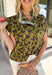 Bring a whimsical touch to your fall wardrobe with this beautifully printed butterfly blouse. Designed in a rich olive green with a striking black butterfly print, this lightweight cotton top offers the perfect balance of playful and polished. The subtle ruffle neckline adds a soft feminine touch, while the button-front detail gives it a timeless feel that's easy to dress up or down.
