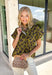 Bring a whimsical touch to your fall wardrobe with this beautifully printed butterfly blouse. Designed in a rich olive green with a striking black butterfly print, this lightweight cotton top offers the perfect balance of playful and polished. The subtle ruffle neckline adds a soft feminine touch, while the button-front detail gives it a timeless feel that's easy to dress up or down.