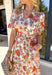 This off white midi dress is bursting with spring color thanks to its vibrant floral print in shades of rust, purple, blue, pink, and brown. The soft cotton fabric keeps it light and breathable, while the flowy midi length makes it perfect for everything from weekend brunch to outdoor showers and special occasions. Designed with feminine puff sleeves and a subtle ruffle neckline, this dress has the sweetest self-tie detail at the top finished with tassels for a playful touch. 