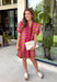 Make a statement this season in this beautifully detailed dress from Entro. Featuring a unique mix of stripes and polka dots in rich shades of plum, burgundy, and olive, this eye-catching dress is full of playful charm with a timeless feel. The flattering v-neckline is accented with decorative front button details, while contrast trim adds an extra touch of personality. 