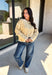 Nothing completes a fall outfit quite like a cozy cardigan. This off white button down cardigan features warm mustard stripes that bring the perfect touch of autumn charm to your wardrobe. The timeless button front makes it easy to wear open or closed, giving you endless styling possibilities throughout the season. Whether you're heading to the office, enjoying a coffee date, or spending the weekend at the pumpkin patch, this soft knit cardigan is one you'll be reaching for again and again.