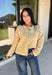 Nothing completes a fall outfit quite like a cozy cardigan. This off white button down cardigan features warm mustard stripes that bring the perfect touch of autumn charm to your wardrobe. The timeless button front makes it easy to wear open or closed, giving you endless styling possibilities throughout the season. Whether you're heading to the office, enjoying a coffee date, or spending the weekend at the pumpkin patch, this soft knit cardigan is one you'll be reaching for again and again.