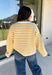 Nothing completes a fall outfit quite like a cozy cardigan. This off white button down cardigan features warm mustard stripes that bring the perfect touch of autumn charm to your wardrobe. The timeless button front makes it easy to wear open or closed, giving you endless styling possibilities throughout the season. Whether you're heading to the office, enjoying a coffee date, or spending the weekend at the pumpkin patch, this soft knit cardigan is one you'll be reaching for again and again.