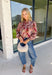 Bring beautiful fall florals into your everyday wardrobe with this effortlessly feminine blouse from Fate. Designed in a soft mauve hue with a floral print in shades of magenta, olive, black, and gray, this timeless top is full of charming details. The button-front design is complemented by a subtle ruffle neckline, while delicate caging detail adds beautiful texture and dimension. 
