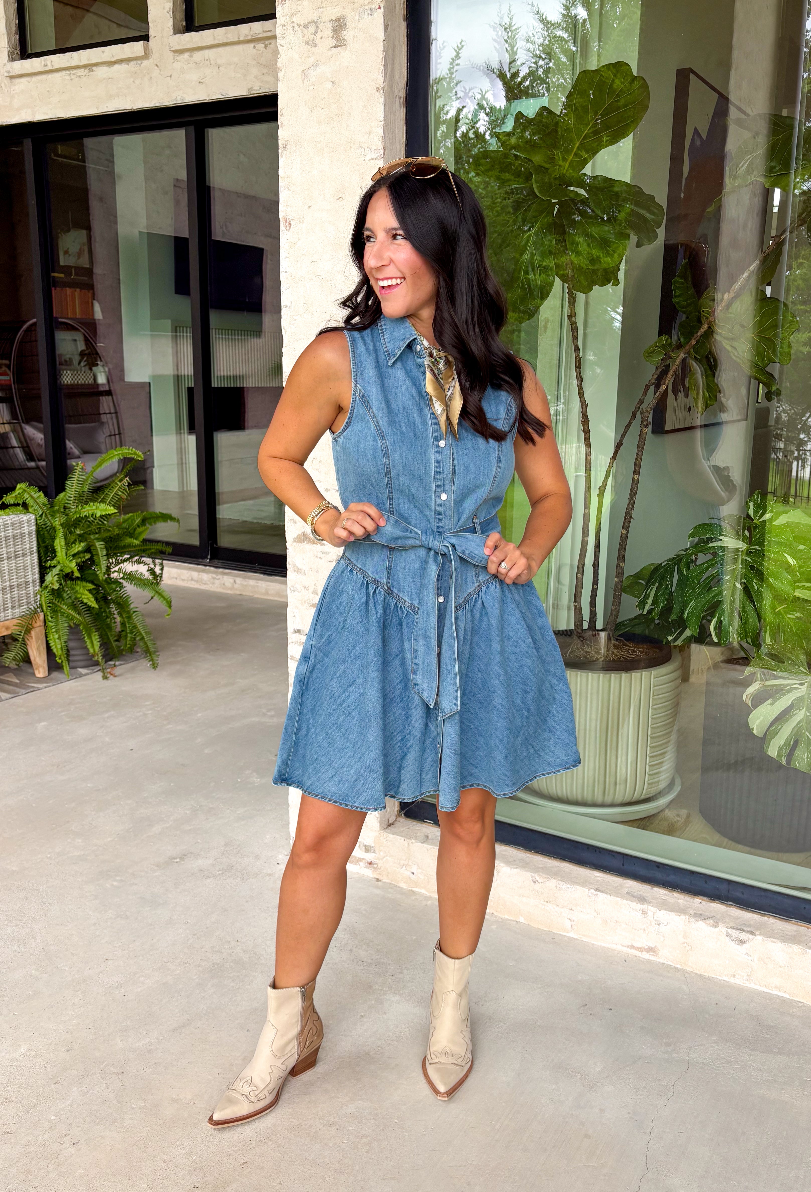 This medium wash denim dress is the kind of effortless piece you'll reach for all summer long! The self-tie sash belt lets you customize the fit, creating a flattering silhouette that's easy to dress up or down. Finished with side pockets (always a win), this dress is equal parts practical and polished. Whether you're heading to brunch, running errands, or headed to a country concert, this versatile dress is ready for it all. Add it to your cart now!