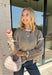 Cozy season calls for an easy sweater you can throw on and instantly feel ready for the day. This light mocha knit sweater from Mable features cream trim throughout, giving the warm neutral color a fresh contrast that stands out without being too bold. The oversized fit creates that relaxed, cozy feel we love for crisp mornings, coffee runs, and laid-back weekends. 