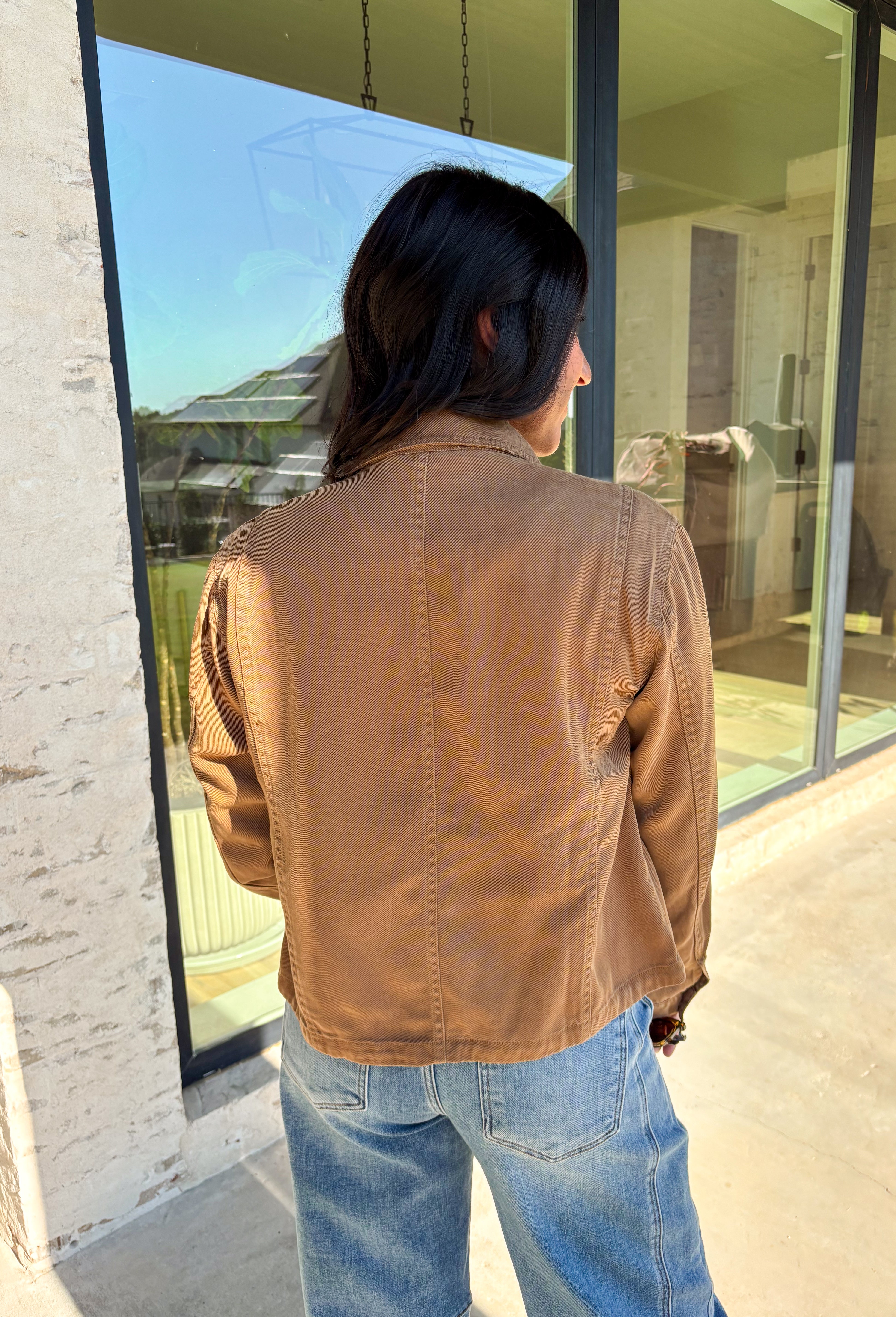 Layering just got easier with this brown lightweight jacket. Designed with a button-down front and collared neckline, it’s a timeless piece that’s easy to style for the season. Front and side pockets keep it functional, while the tencel-cotton-linen blend gives it a soft, breathable feel. Perfect for throwing over sweaters, tees, or dresses, this jacket is a go-to for those crisp fall days when you want an effortless extra layer.