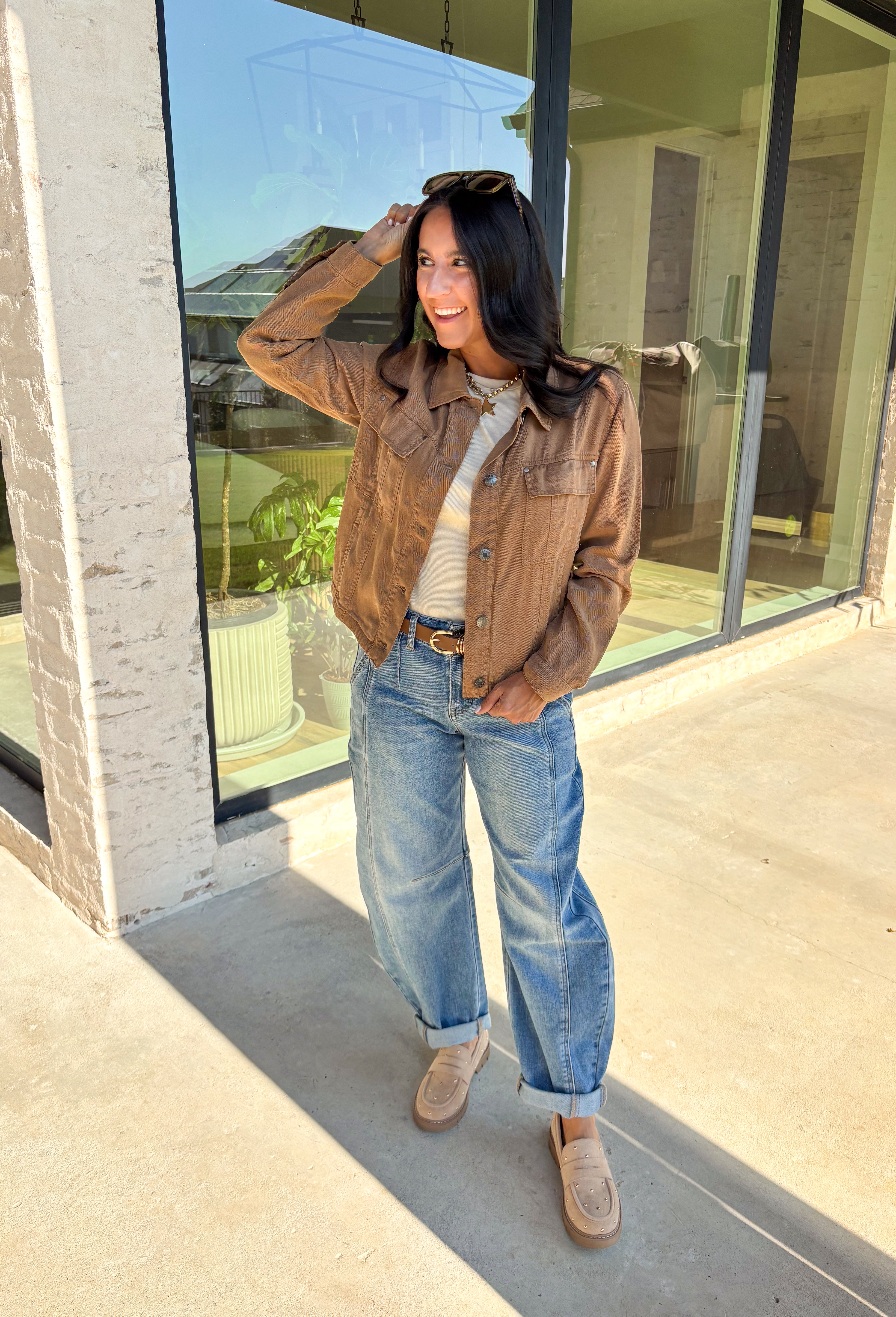 Layering just got easier with this brown lightweight jacket. Designed with a button-down front and collared neckline, it’s a timeless piece that’s easy to style for the season. Front and side pockets keep it functional, while the tencel-cotton-linen blend gives it a soft, breathable feel. Perfect for throwing over sweaters, tees, or dresses, this jacket is a go-to for those crisp fall days when you want an effortless extra layer.