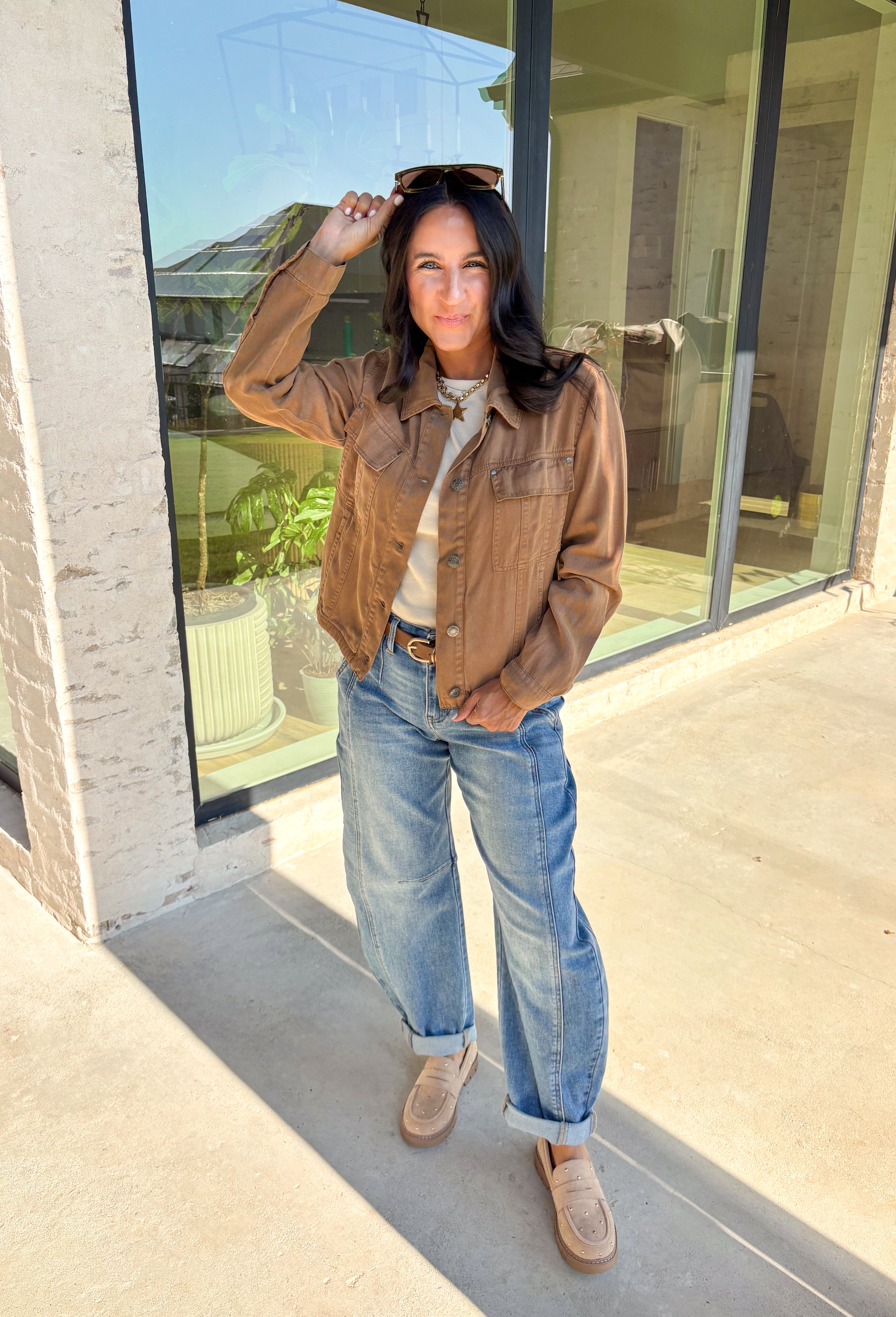 Layering just got easier with this brown lightweight jacket. Designed with a button-down front and collared neckline, it’s a timeless piece that’s easy to style for the season. Front and side pockets keep it functional, while the tencel-cotton-linen blend gives it a soft, breathable feel. Perfect for throwing over sweaters, tees, or dresses, this jacket is a go-to for those crisp fall days when you want an effortless extra layer.