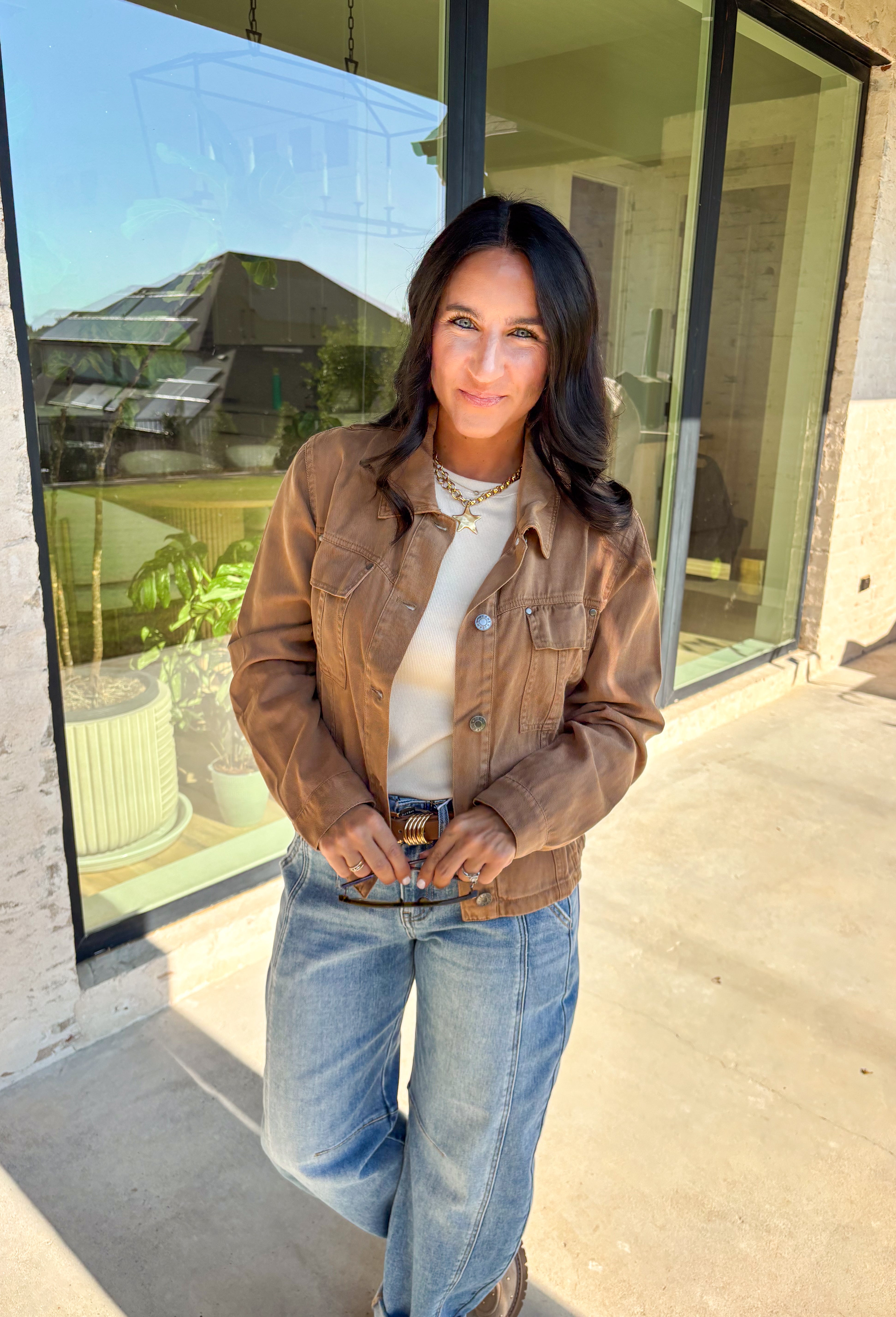 Layering just got easier with this brown lightweight jacket. Designed with a button-down front and collared neckline, it’s a timeless piece that’s easy to style for the season. Front and side pockets keep it functional, while the tencel-cotton-linen blend gives it a soft, breathable feel. Perfect for throwing over sweaters, tees, or dresses, this jacket is a go-to for those crisp fall days when you want an effortless extra layer.