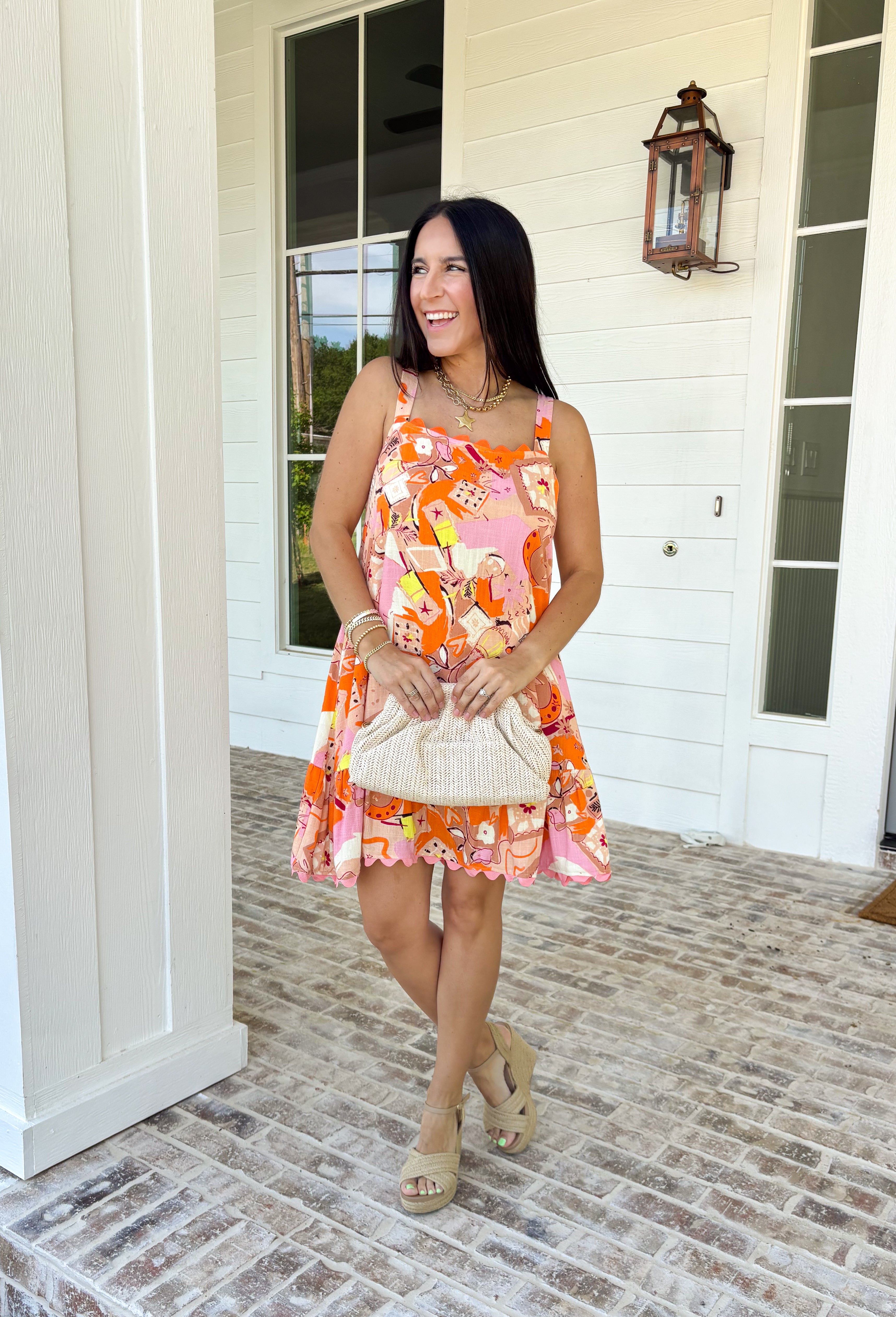 Make an entrance in this bold abstract print dress that was made for sunny days and standout moments. With vibrant shades of orange, pink, tan, black, yellow, and white throughout, this sleeveless beauty feels like wearable art. The orange scallop trim along the neckline and pink scallop trim at the hem add the sweetest contrast, giving it that extra pop of personality. Lightweight and fully lined for easy wear.