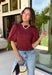 Rich autumn color and feminine details come together beautifully in this brick peplum top. Designed with a flattering smocked bodice, this top offers a comfortable fit while creating a timeless silhouette you'll love. The delicate ruffle neckline and ruffle hem add just the right amount of charm, while the puff sleeves complete the look with a classic fall feel. 