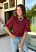 Rich autumn color and feminine details come together beautifully in this brick peplum top. Designed with a flattering smocked bodice, this top offers a comfortable fit while creating a timeless silhouette you'll love. The delicate ruffle neckline and ruffle hem add just the right amount of charm, while the puff sleeves complete the look with a classic fall feel. 