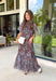 Turn heads at your next special event in this stunning floral maxi dress from Entro. Featuring a rich brown backdrop with a beautiful blue floral print, this elegant dress is designed to make every occasion feel a little more special. The self-tie detail at the back neckline adds a graceful finishing touch, while the flowing maxi silhouette creates effortless movement with every step. 