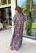 Turn heads at your next special event in this stunning floral maxi dress from Entro. Featuring a rich brown backdrop with a beautiful blue floral print, this elegant dress is designed to make every occasion feel a little more special. The self-tie detail at the back neckline adds a graceful finishing touch, while the flowing maxi silhouette creates effortless movement with every step. 