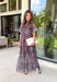 Turn heads at your next special event in this stunning floral maxi dress from Entro. Featuring a rich brown backdrop with a beautiful blue floral print, this elegant dress is designed to make every occasion feel a little more special. The self-tie detail at the back neckline adds a graceful finishing touch, while the flowing maxi silhouette creates effortless movement with every step. 