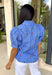 This blue short sleeve top by Entro is giving the perfect mix of classic and cute for spring. Featuring a crisp white stripe print with delicate floral embroidery in green and pink, it’s one of those tops that feels extra special without trying too hard. The button-front design and subtle ruffle detail add a sweet finishing touch, making it easy to dress up with white denim or keep casual with your favorite everyday jeans.