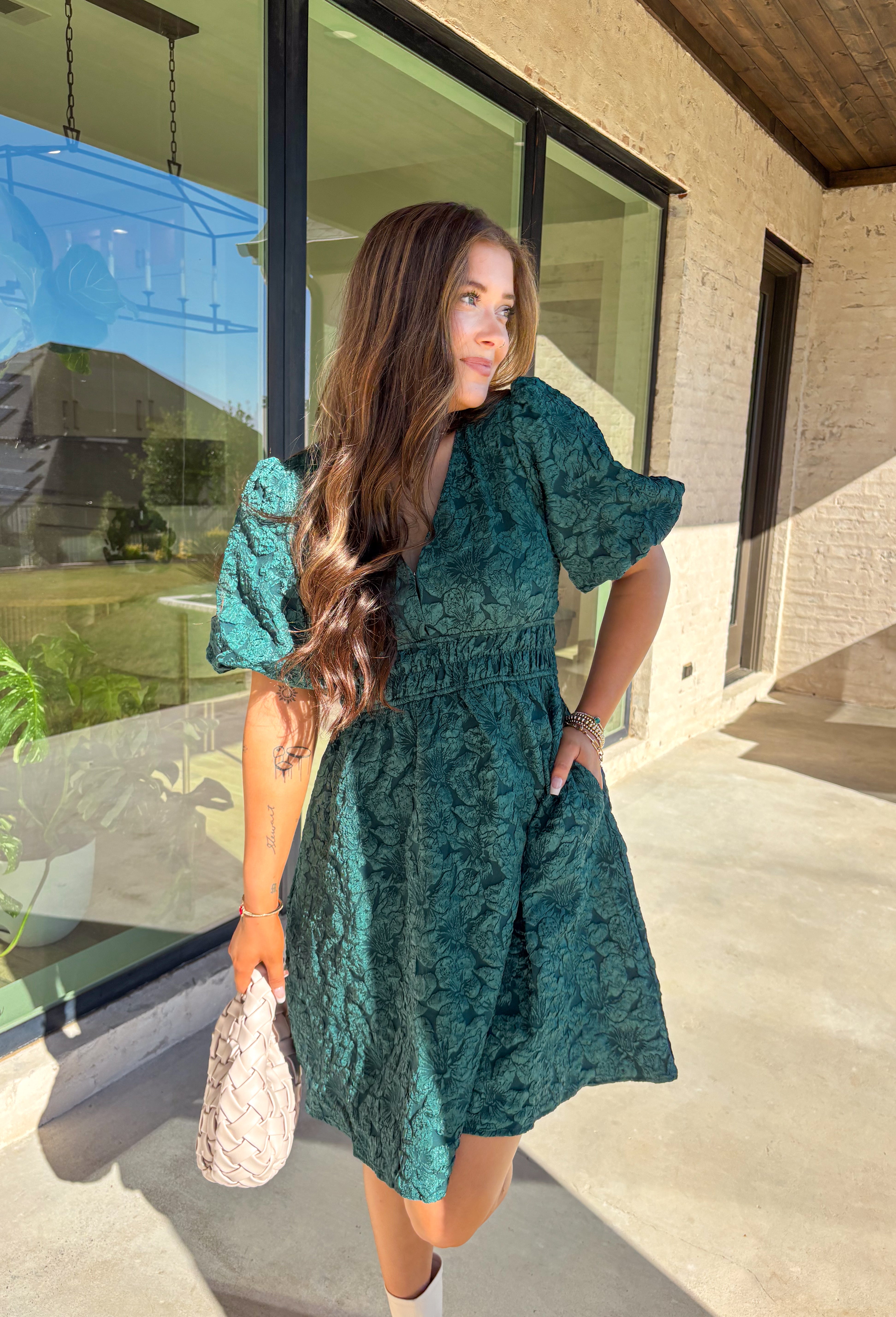 This green short sleeve dress by She + Sky brings an elegant touch to your wardrobe with its monochromatic floral texture that gives a lace-like look—perfect for the holiday season. The puff sleeves and elastic waist create a flattering, feminine silhouette, while the fully lined design ensures comfort from dinner parties to festive gatherings. It’s a chic, effortless piece you’ll reach for all winter long.