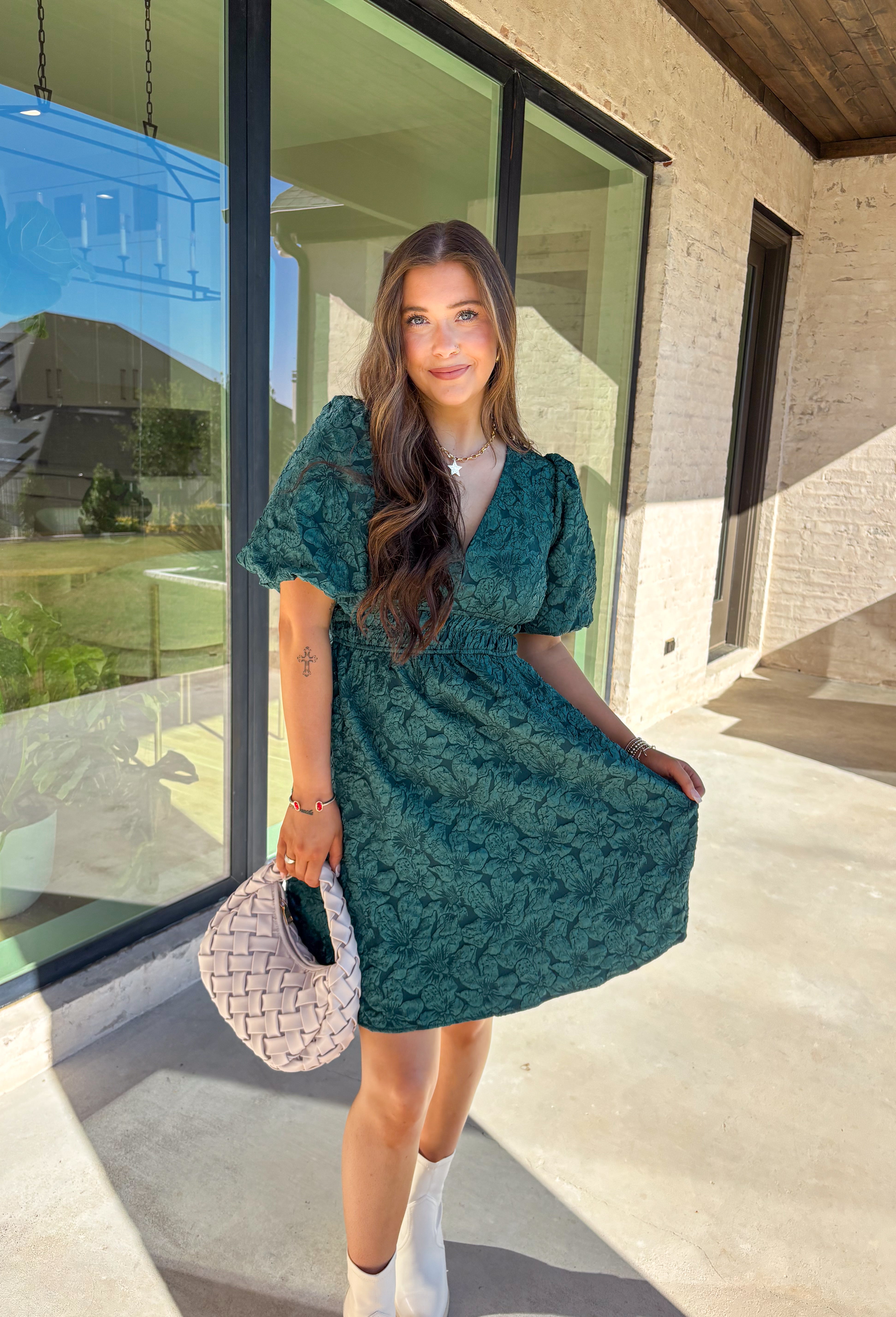This green short sleeve dress by She + Sky brings an elegant touch to your wardrobe with its monochromatic floral texture that gives a lace-like look—perfect for the holiday season. The puff sleeves and elastic waist create a flattering, feminine silhouette, while the fully lined design ensures comfort from dinner parties to festive gatherings. It’s a chic, effortless piece you’ll reach for all winter long.
