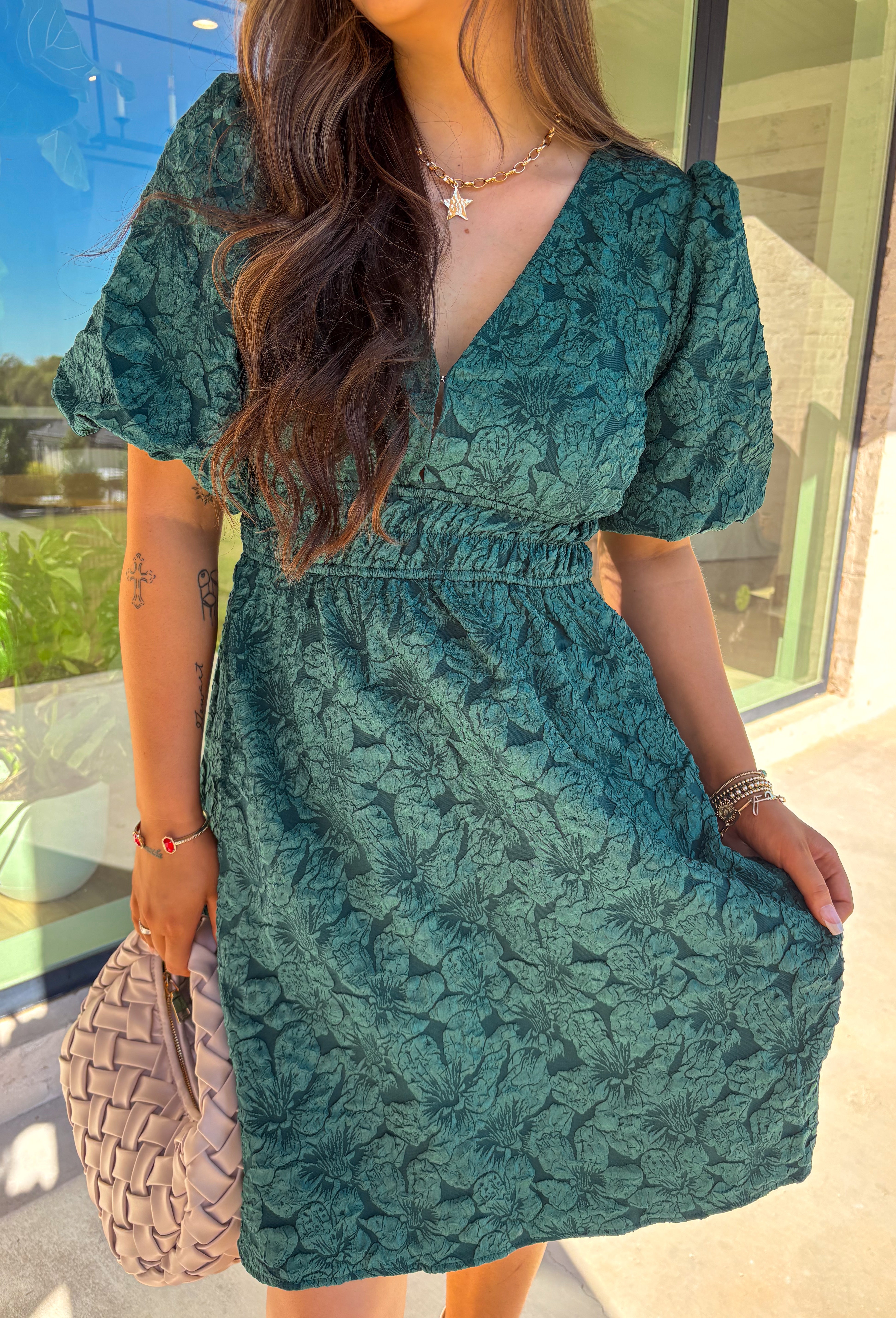 This green short sleeve dress by She + Sky brings an elegant touch to your wardrobe with its monochromatic floral texture that gives a lace-like look—perfect for the holiday season. The puff sleeves and elastic waist create a flattering, feminine silhouette, while the fully lined design ensures comfort from dinner parties to festive gatherings. It’s a chic, effortless piece you’ll reach for all winter long.