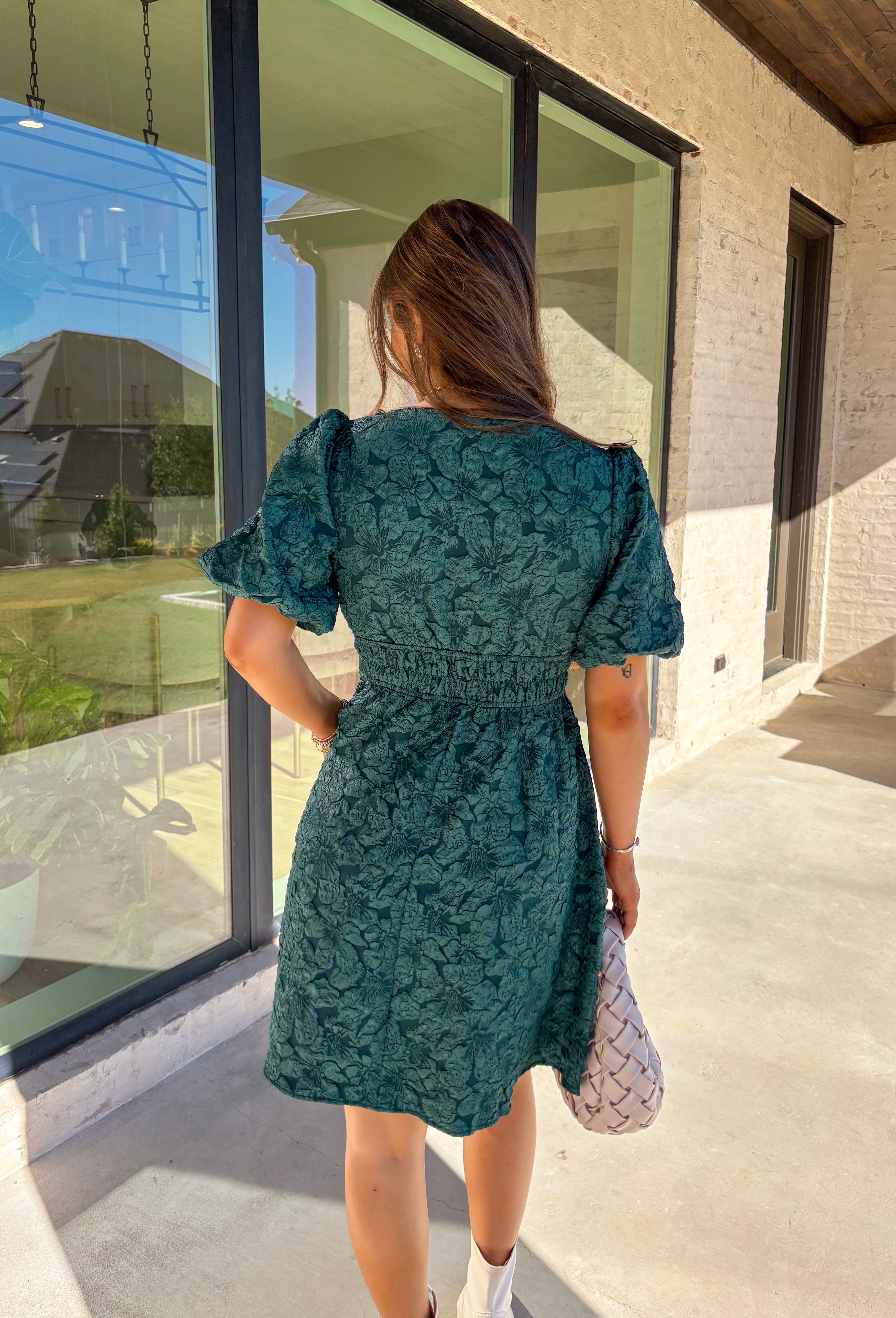 This green short sleeve dress by She + Sky brings an elegant touch to your wardrobe with its monochromatic floral texture that gives a lace-like look—perfect for the holiday season. The puff sleeves and elastic waist create a flattering, feminine silhouette, while the fully lined design ensures comfort from dinner parties to festive gatherings. It’s a chic, effortless piece you’ll reach for all winter long.