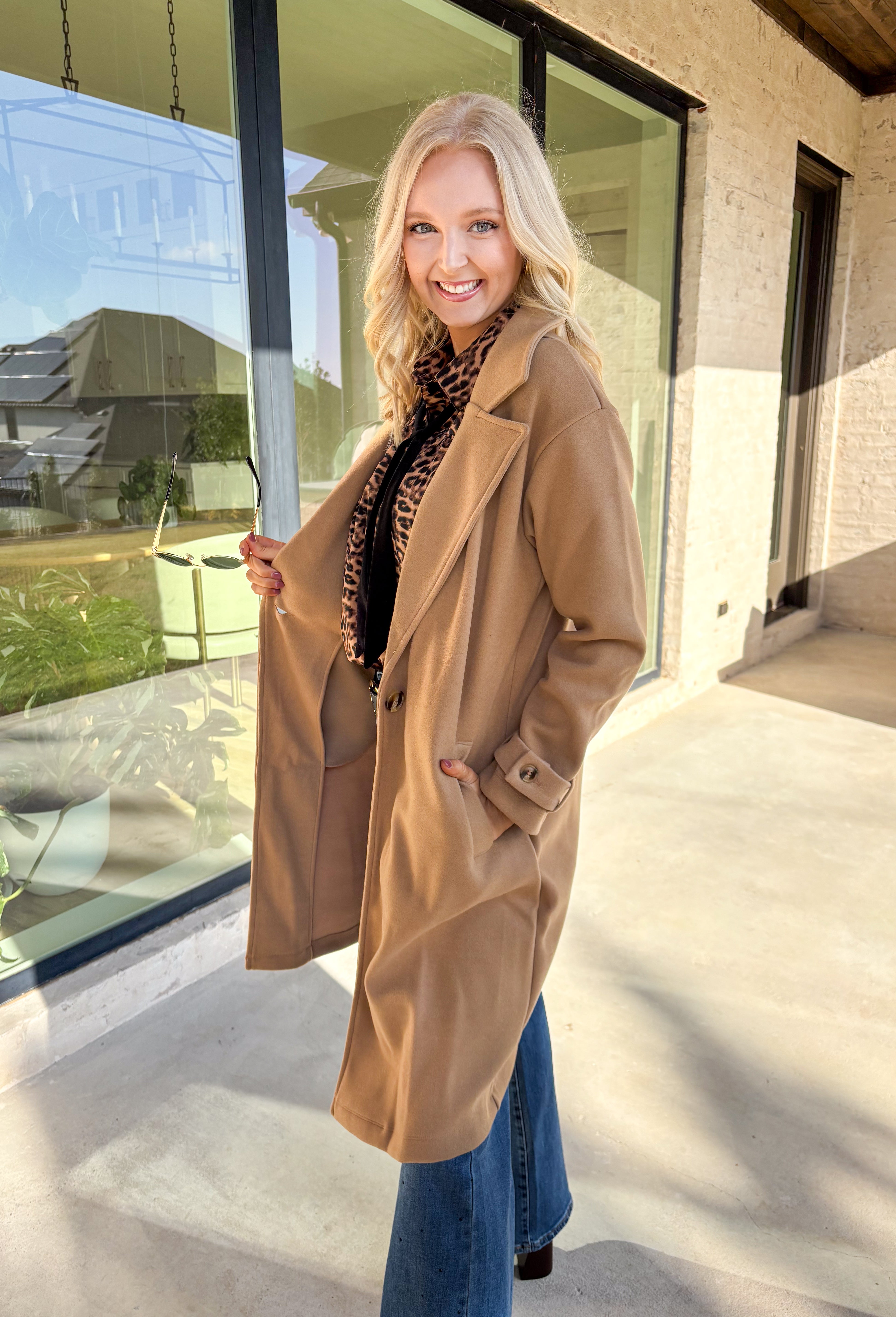 Timeless and cozy, this camel trench coat jacket by Haute Monde is a cold-weather essential you’ll reach for again and again. With a classic button front and side pockets, this piece brings effortless polish to any winter outfit. The soft fabric and tailored silhouette make it perfect for layering over chunky knits or dresses on chilly days.