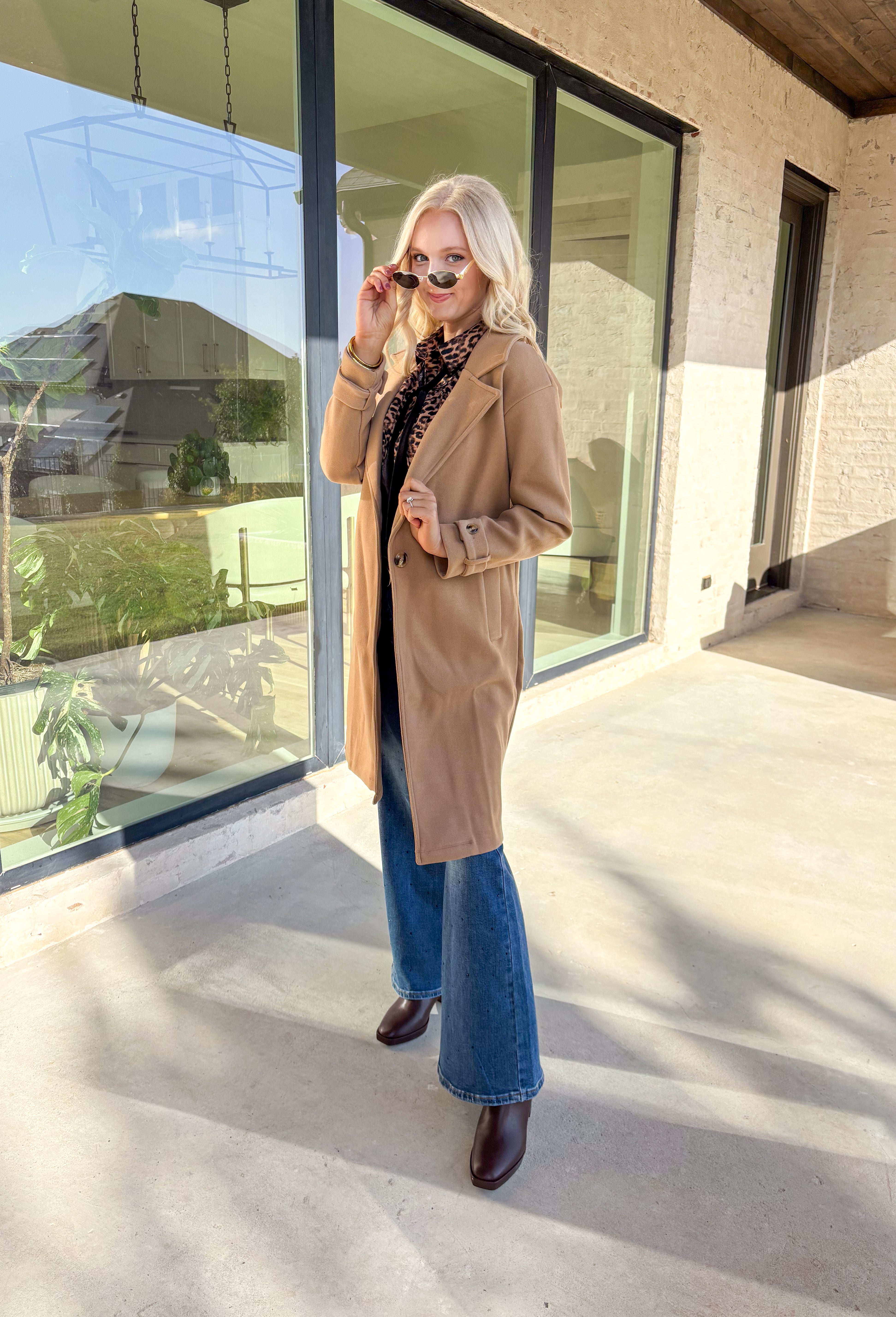 Timeless and cozy, this camel trench coat jacket by Haute Monde is a cold-weather essential you’ll reach for again and again. With a classic button front and side pockets, this piece brings effortless polish to any winter outfit. The soft fabric and tailored silhouette make it perfect for layering over chunky knits or dresses on chilly days.