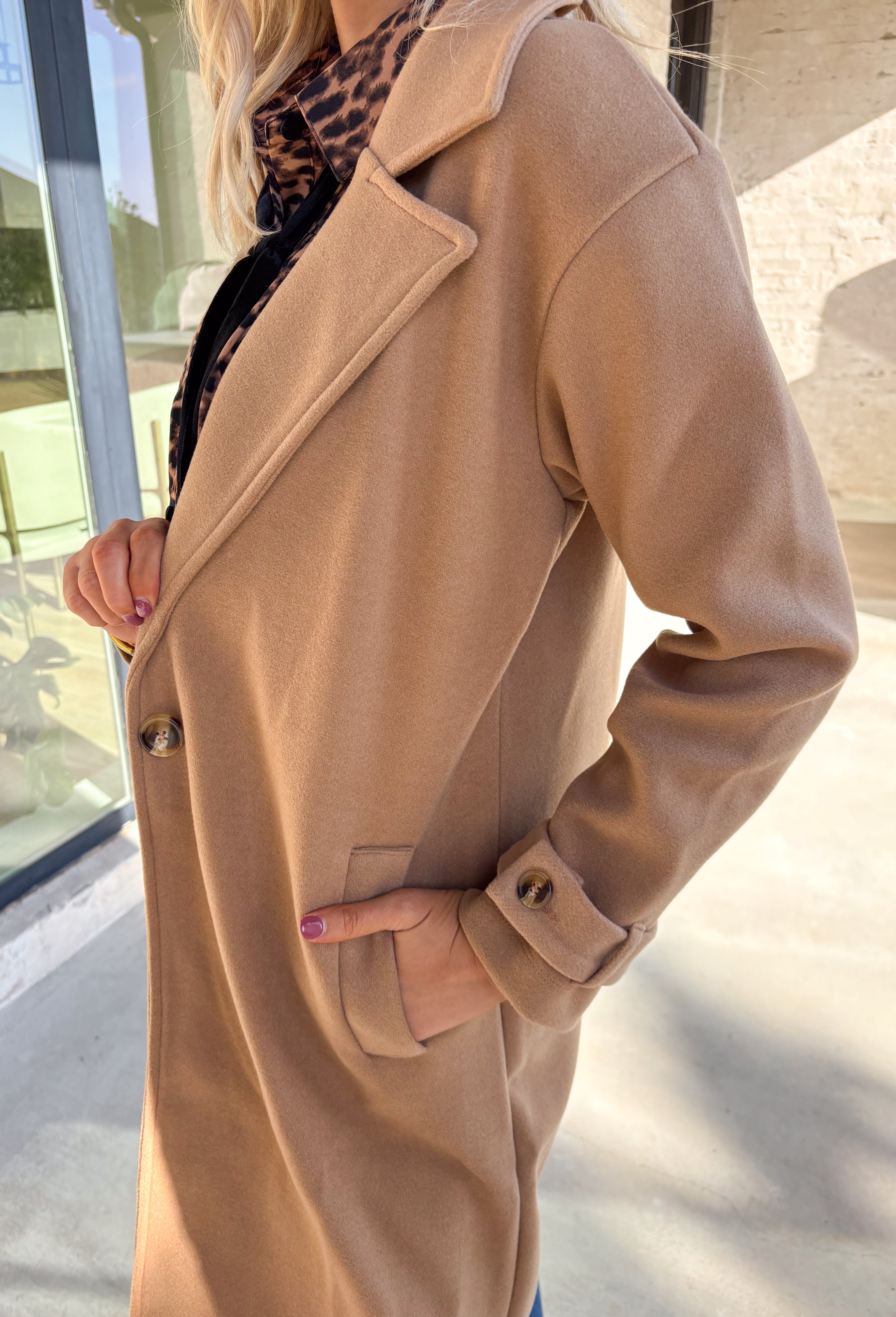 Timeless and cozy, this camel trench coat jacket by Haute Monde is a cold-weather essential you’ll reach for again and again. With a classic button front and side pockets, this piece brings effortless polish to any winter outfit. The soft fabric and tailored silhouette make it perfect for layering over chunky knits or dresses on chilly days.
