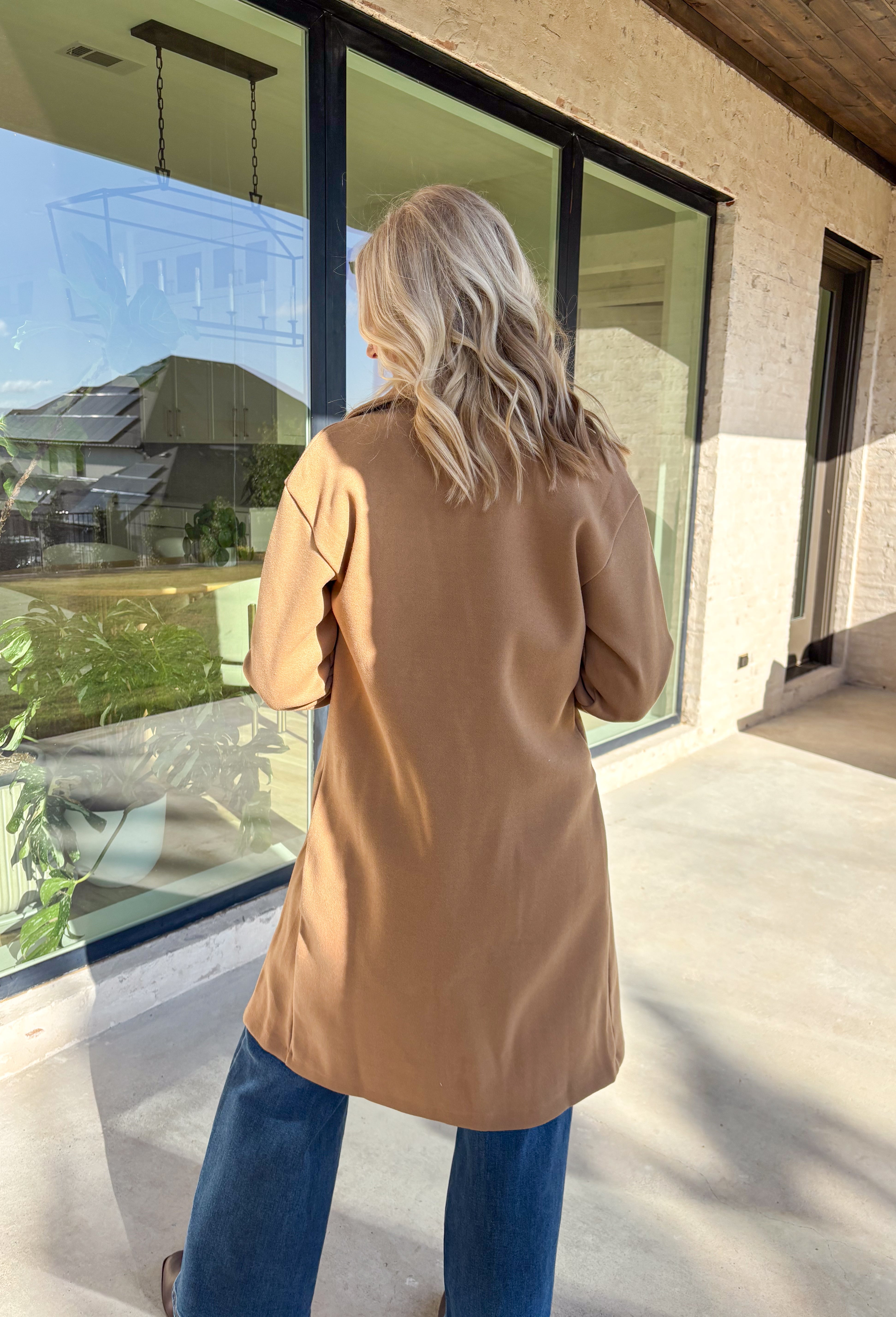 Timeless and cozy, this camel trench coat jacket by Haute Monde is a cold-weather essential you’ll reach for again and again. With a classic button front and side pockets, this piece brings effortless polish to any winter outfit. The soft fabric and tailored silhouette make it perfect for layering over chunky knits or dresses on chilly days.