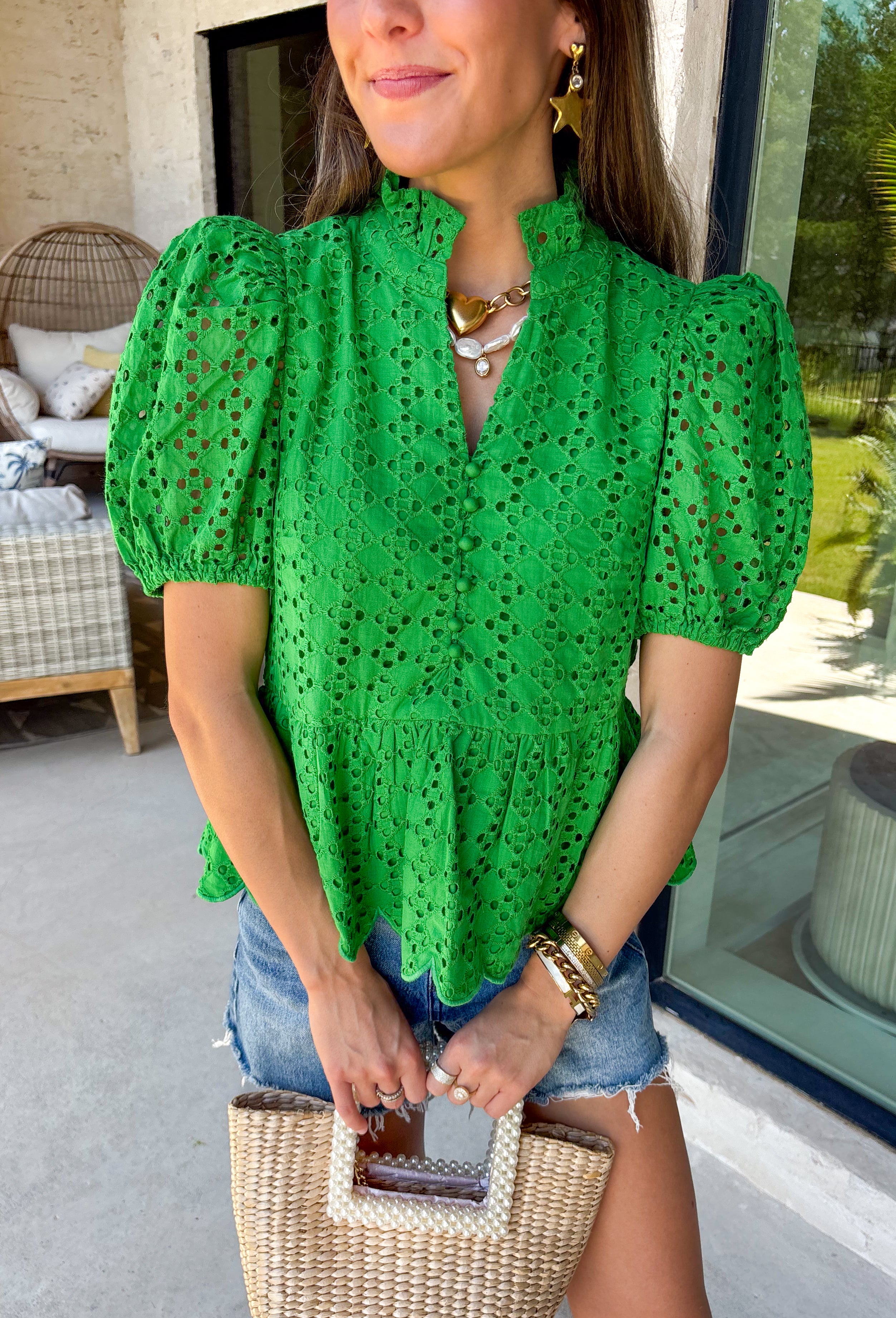 This green eyelet top is such a fresh and feminine pick for summer! The intricate eyelet embroidery adds the prettiest texture, while the puff sleeves and elastic openings create that flattering, easy shape. The ruffled neckline with a soft v-neck adds a touch of charm, and the scalloped hem gives it that extra detail that makes it feel special. Lightweight and breathable in 100% cotton, it’s perfect for warm days when you want to look put together without overthinking it. 