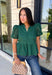 Elevate your fall wardrobe with this beautifully detailed hunter green top! Crafted from breathable cotton, this feminine top features intricate eyelet embroidery that adds timeless texture and charm. The ruffled accent neckline and flattering v-neck create an effortlessly polished look, while the button front and short puff sleeves with elastic cuffs offer both comfort and style. 