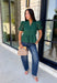 Elevate your fall wardrobe with this beautifully detailed hunter green top! Crafted from breathable cotton, this feminine top features intricate eyelet embroidery that adds timeless texture and charm. The ruffled accent neckline and flattering v-neck create an effortlessly polished look, while the button front and short puff sleeves with elastic cuffs offer both comfort and style. 