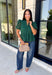 Elevate your fall wardrobe with this beautifully detailed hunter green top! Crafted from breathable cotton, this feminine top features intricate eyelet embroidery that adds timeless texture and charm. The ruffled accent neckline and flattering v-neck create an effortlessly polished look, while the button front and short puff sleeves with elastic cuffs offer both comfort and style. 