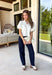 Every wardrobe needs a timeless white denim top, and this one is sure to become a favorite. Crafted from crisp 100% cotton, this classic piece features beautiful tan contrast stitching that adds warmth and dimension to the clean white denim. Feminine puff sleeves give this everyday staple a stylish update, while the collared neckline and front pockets keep the look polished and versatile. You'll find yourself reaching for this top constantly!