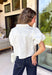 Every wardrobe needs a timeless white denim top, and this one is sure to become a favorite. Crafted from crisp 100% cotton, this classic piece features beautiful tan contrast stitching that adds warmth and dimension to the clean white denim. Feminine puff sleeves give this everyday staple a stylish update, while the collared neckline and front pockets keep the look polished and versatile. You'll find yourself reaching for this top constantly!
