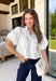Every wardrobe needs a timeless white denim top, and this one is sure to become a favorite. Crafted from crisp 100% cotton, this classic piece features beautiful tan contrast stitching that adds warmth and dimension to the clean white denim. Feminine puff sleeves give this everyday staple a stylish update, while the collared neckline and front pockets keep the look polished and versatile. You'll find yourself reaching for this top constantly!